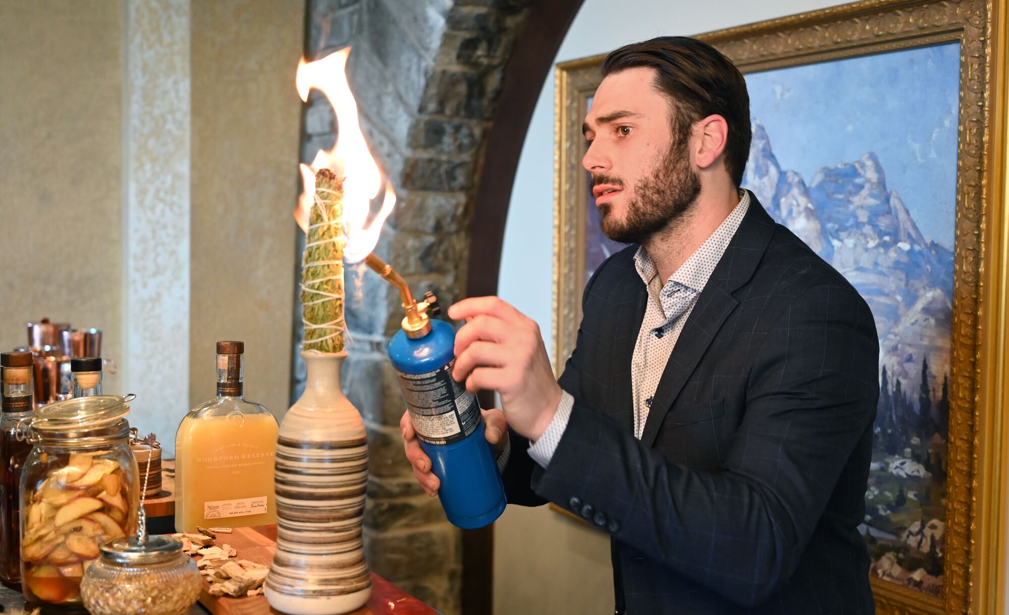 A bartender fires off a torch while making a fancy cocktail at the Banff Food & Cocktail Festival.
